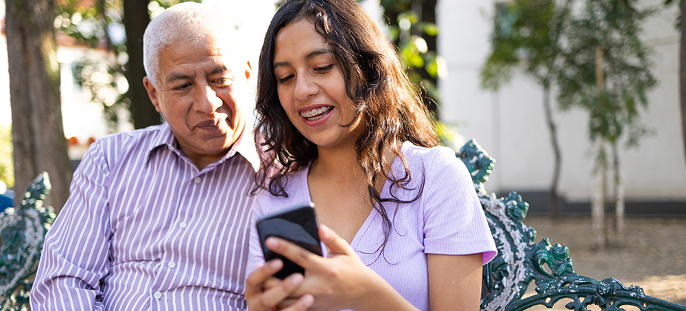 Grandfather and Child look at text messages together