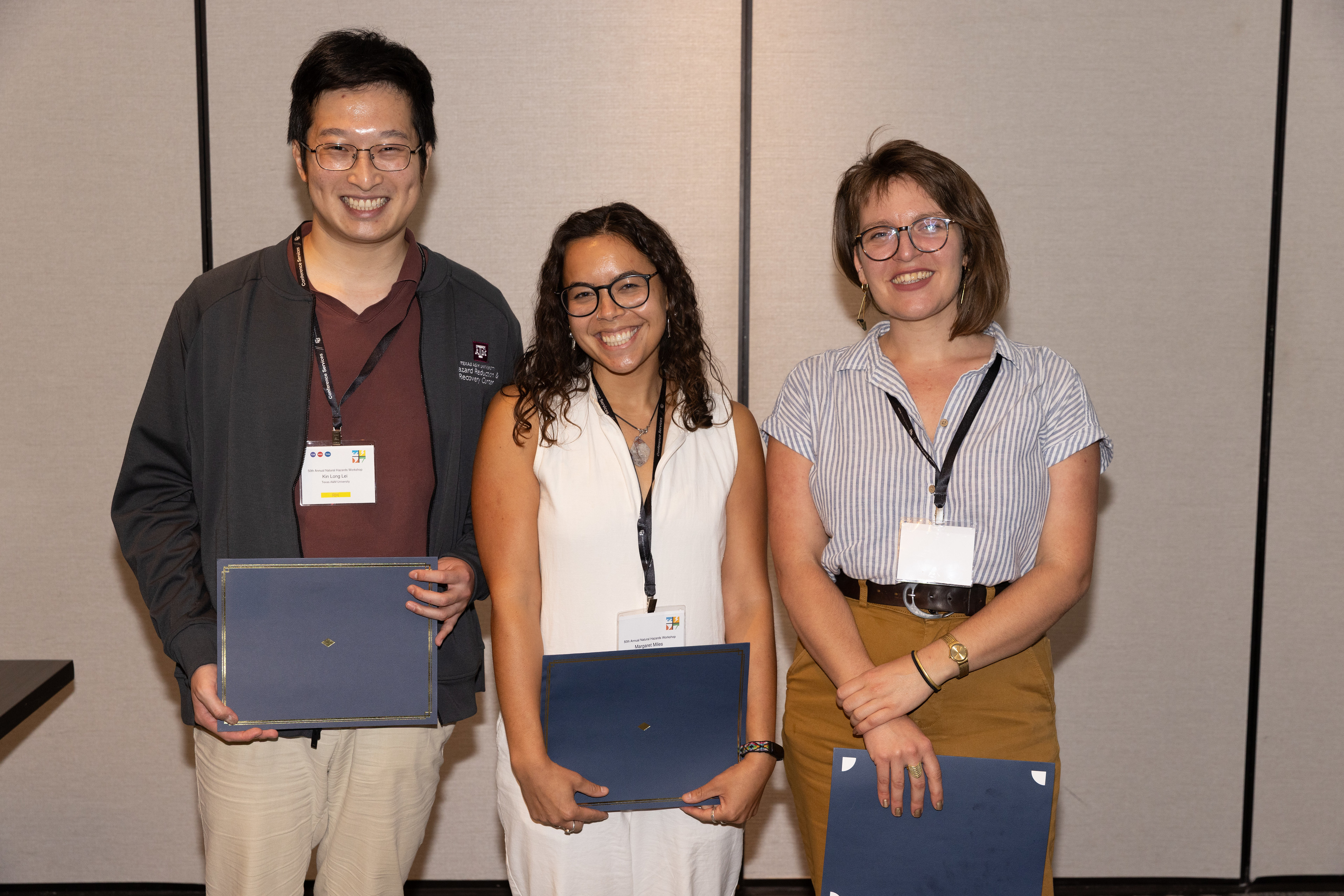Three student prize winners pose for a photo together