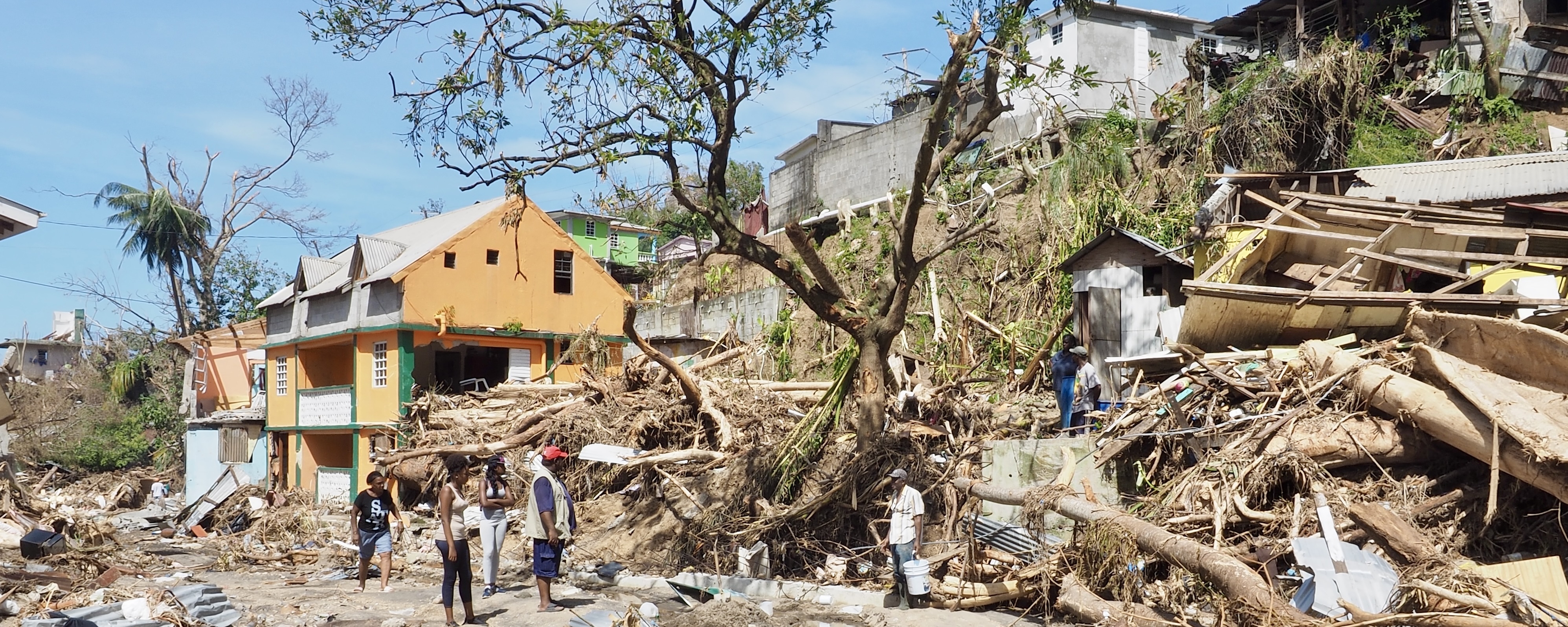 Residents survey the aftermath of Hurricane Maria on the island Dominica in September, 2017.
