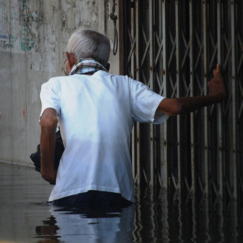 Man Wading Through Flood