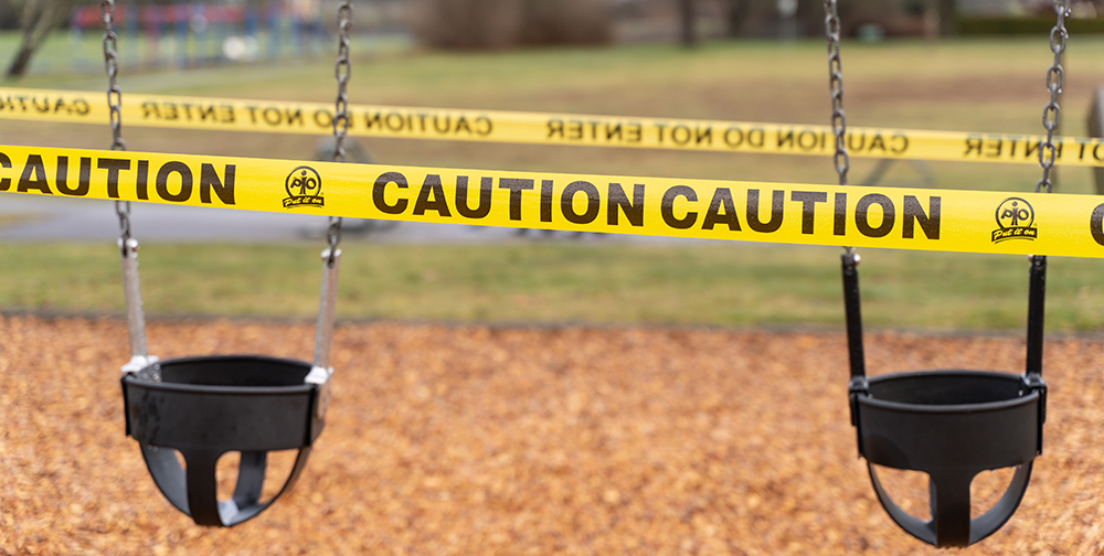 Image of toddler swings wrapped in yellow and black caution tape