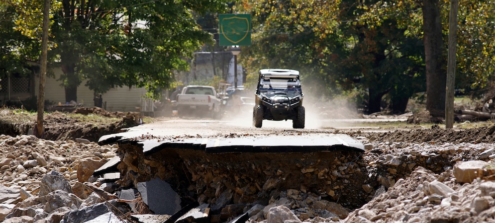 A truck sits at the edge of a destroyed roadway in North Carolina.