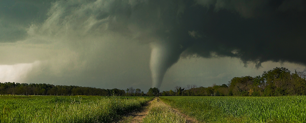 A tornado looms over open farm land