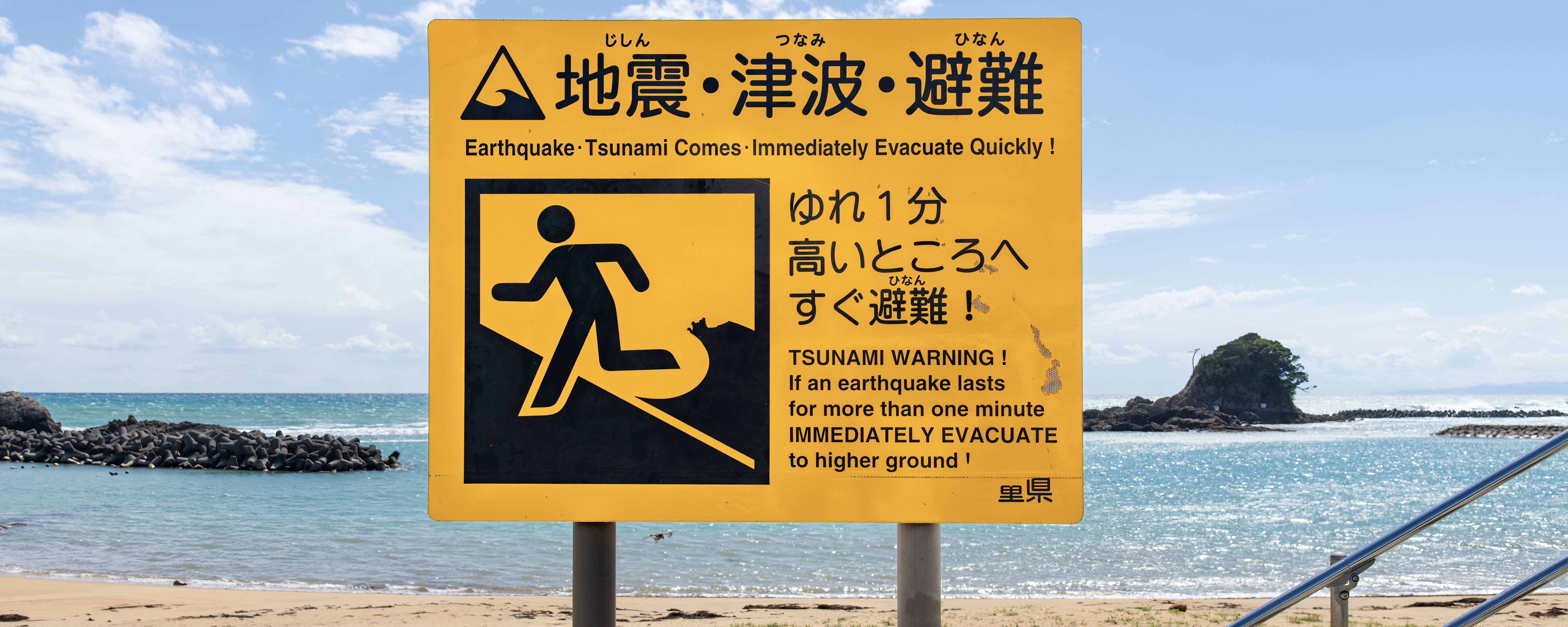 Large notice board on a beach in Japan warning for Tsunamis in case of an earthquake