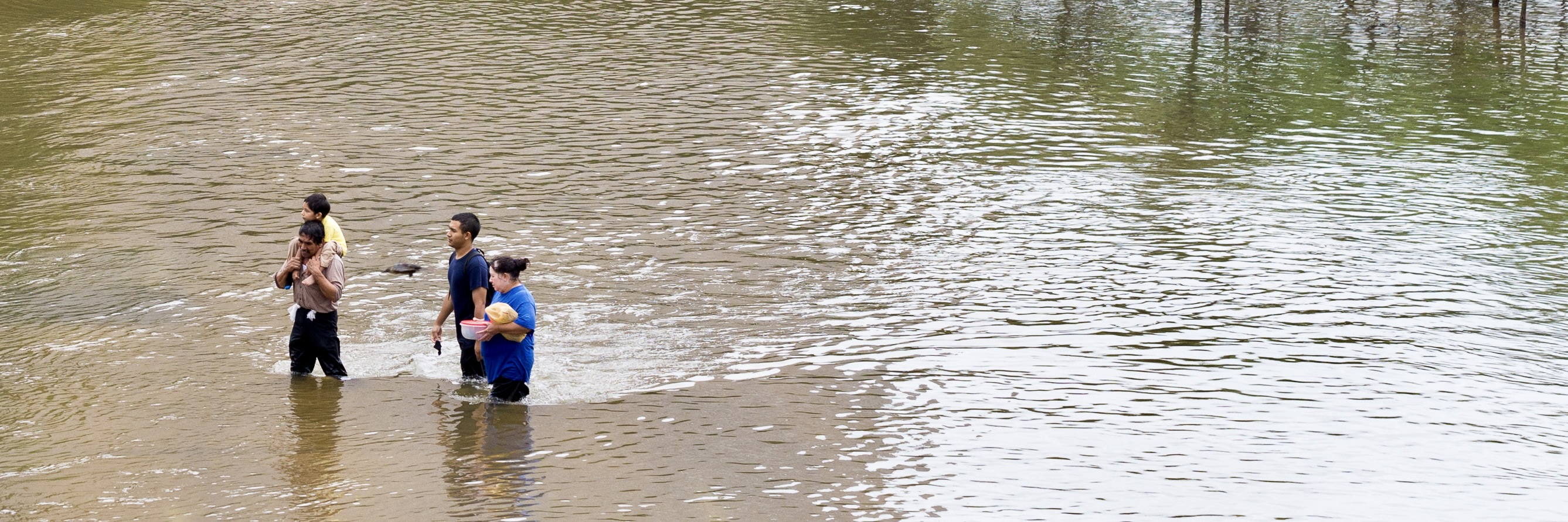 Residents walk across the flooded street in Houston, Texas during Hurricane Harvey in 2017. Source: Michel Mond / Shutterstock.com